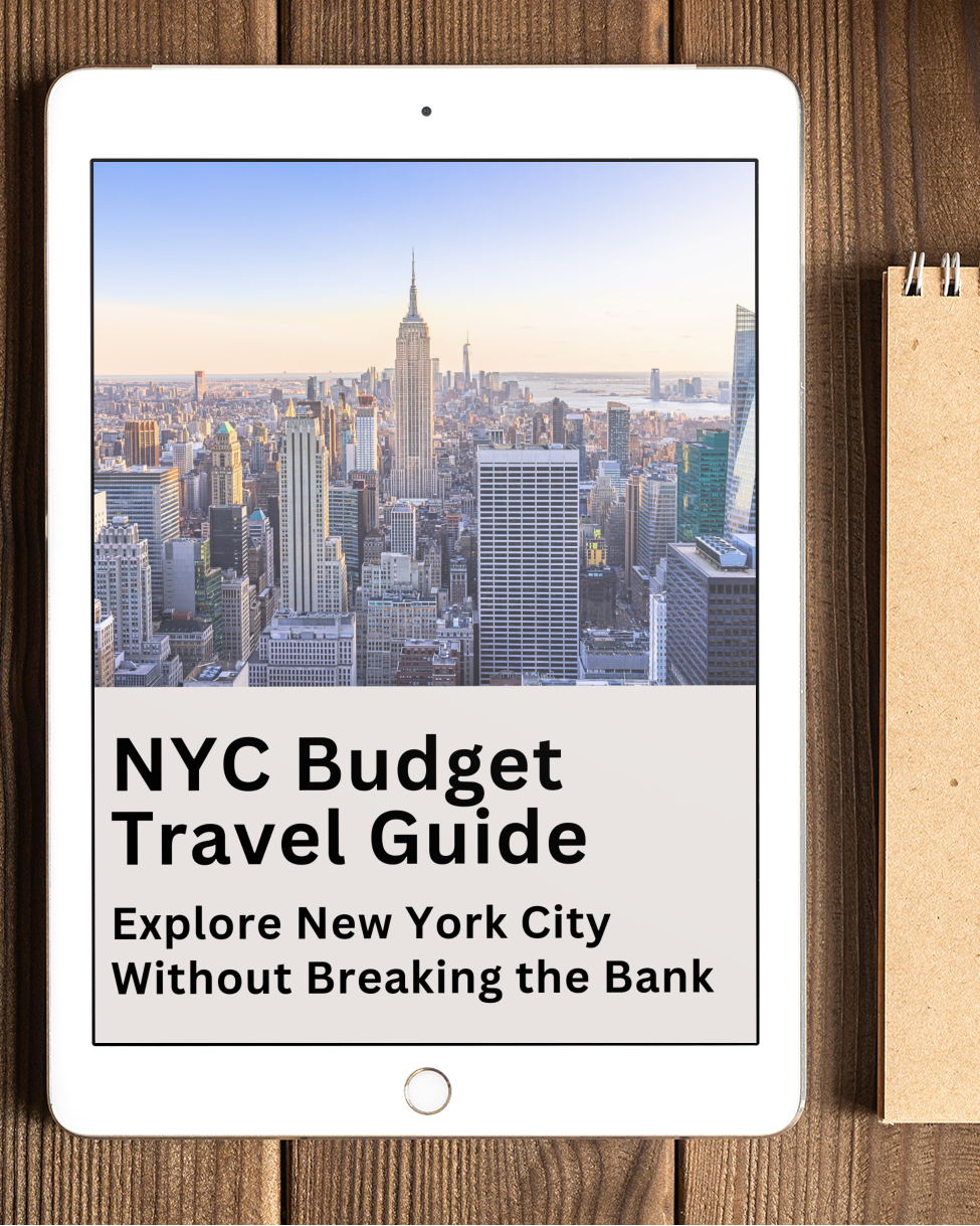 iPad displaying a NYC Budget Travel Guide on a wooden table with a notebook and pen.